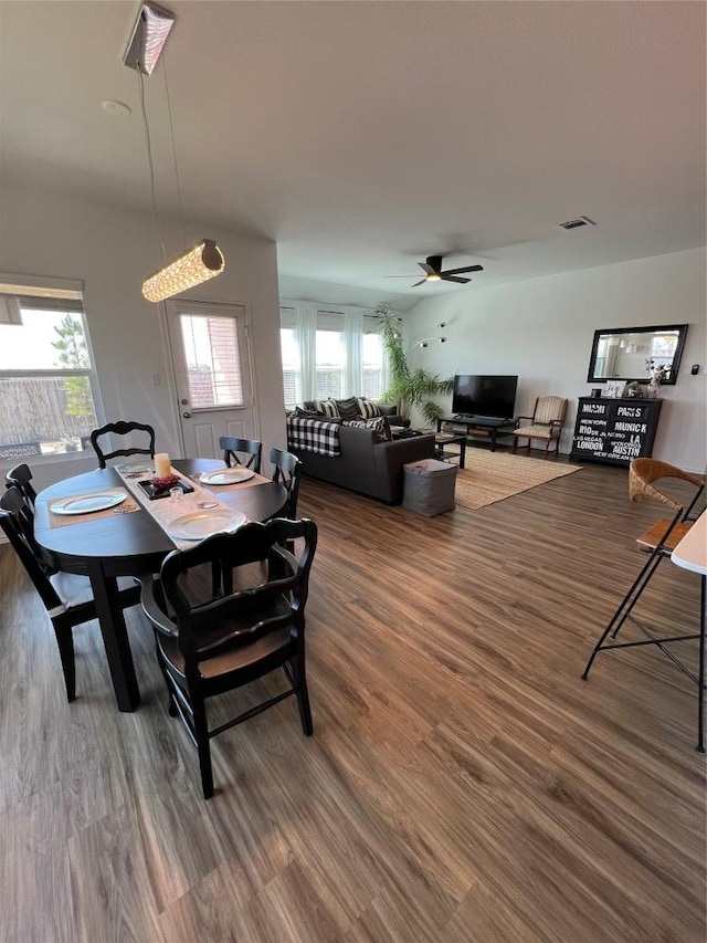 dining space with a healthy amount of sunlight, ceiling fan, and wood finished floors