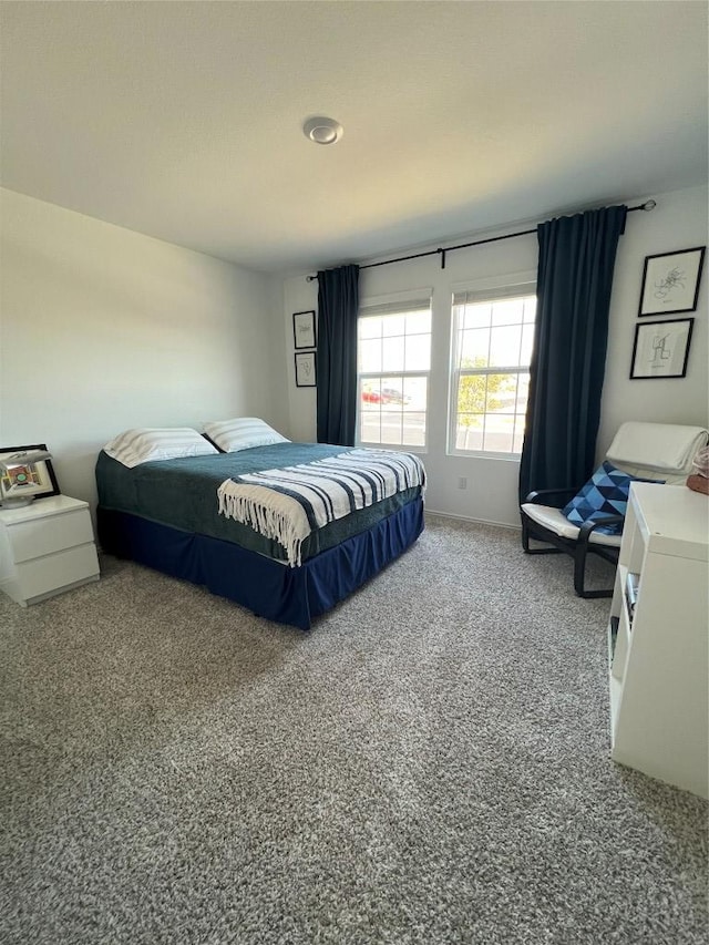 carpeted bedroom featuring baseboards