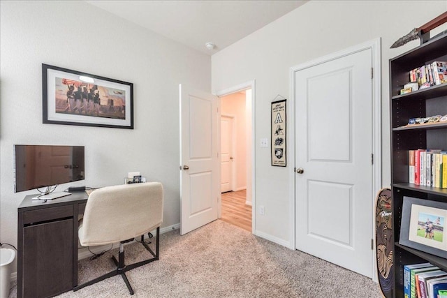 home office with light colored carpet and baseboards