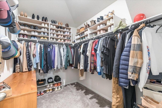 spacious closet with vaulted ceiling and carpet flooring