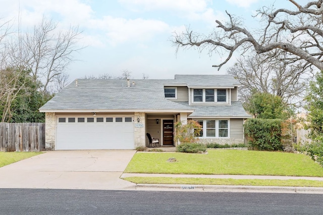 view of front of home featuring fence, an attached garage, a front lawn, concrete driveway, and stone siding