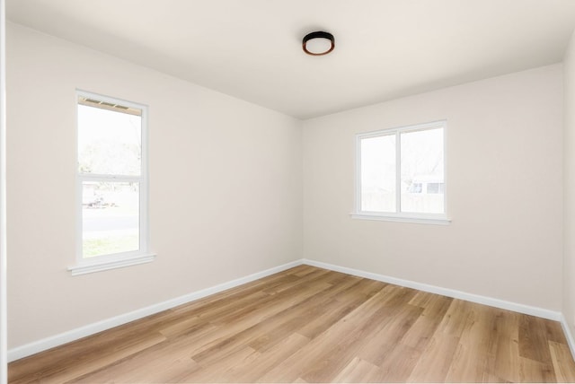 empty room with light wood-style floors and baseboards