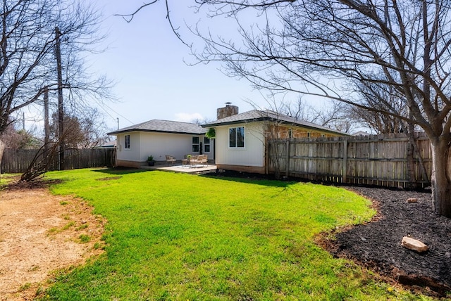 rear view of property with a patio area, a fenced backyard, a lawn, and a chimney