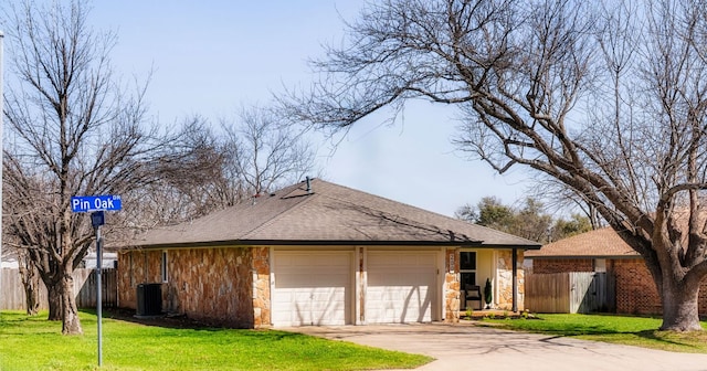 view of front of property featuring stone siding, fence, and central AC unit