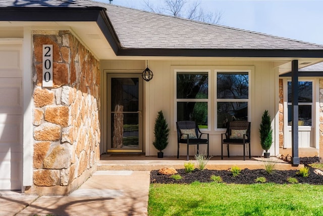 property entrance featuring a porch and roof with shingles