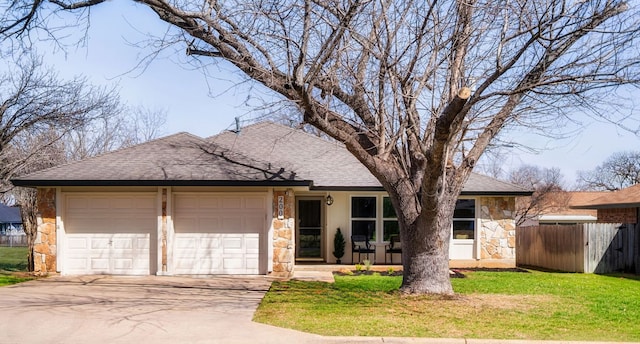 single story home with a shingled roof, stone siding, and fence