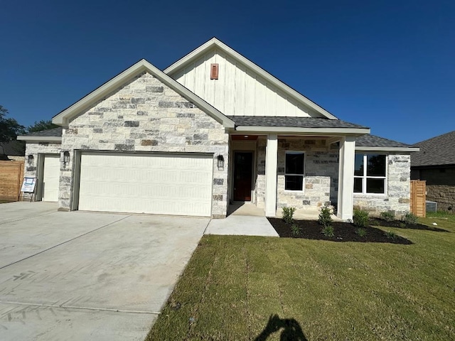 421 Spyglass St, Meadowlakes, TX 78654 - view of front of property featuring a garage, board and batten siding, concrete driveway, a front yard, and stone siding