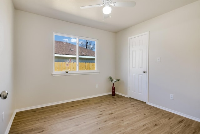 unfurnished room featuring baseboards, ceiling fan, and light wood finished floors