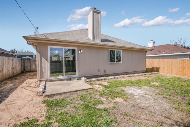 rear view of property with a patio area and a fenced backyard