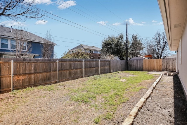 view of yard with a fenced backyard