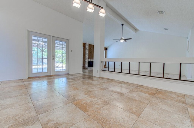 unfurnished living room with visible vents, ceiling fan, beamed ceiling, a textured ceiling, and french doors