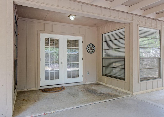 doorway featuring french doors and wood walls