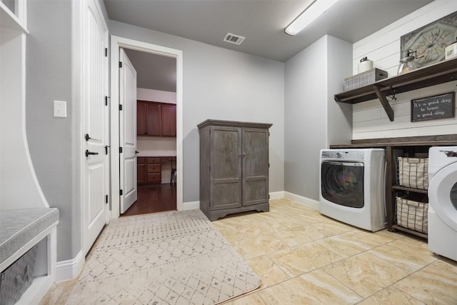 laundry room featuring baseboards, laundry area, visible vents, and washer and dryer