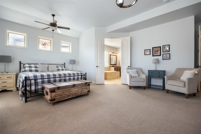 bedroom featuring ensuite bathroom, carpet floors, multiple windows, and a ceiling fan