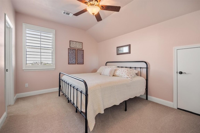 bedroom with lofted ceiling, baseboards, visible vents, and light colored carpet