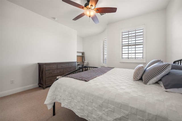 bedroom featuring light carpet, ceiling fan, and baseboards