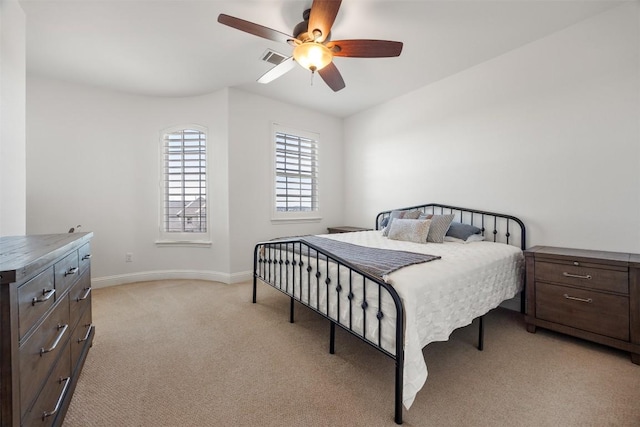 bedroom featuring light carpet, ceiling fan, visible vents, and baseboards