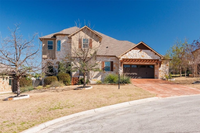 french country style house featuring a garage, stone siding, driveway, roof with shingles, and a front yard