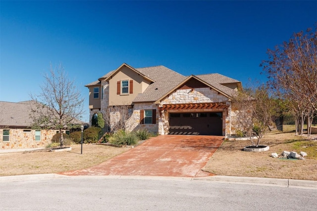 view of front of property with a garage, stone siding, driveway, and stucco siding