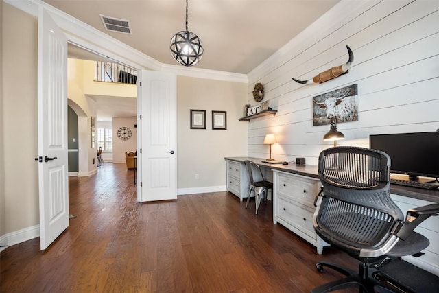 home office with dark wood-style floors, arched walkways, crown molding, visible vents, and baseboards