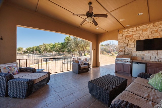 view of patio / terrace with ceiling fan, a grill, exterior kitchen, an outdoor living space, and a sink