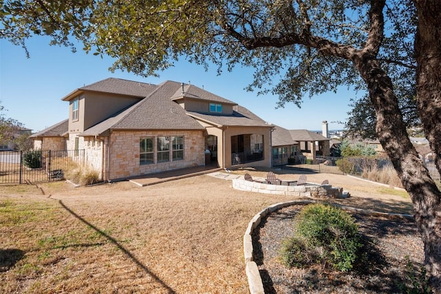 rear view of property featuring a lawn, a patio area, fence, and stucco siding