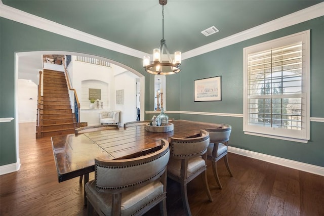 205 Agave Bloom Cv, Austin, TX 78738 - dining space with baseboards, a chandelier, arched walkways, stairs, and crown molding