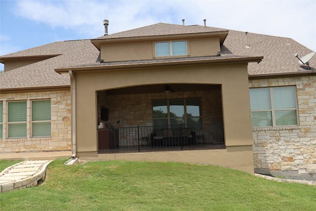 205 Agave Bloom Cv, Austin, TX 78738 - rear view of property featuring stone siding, a yard, and roof with shingles