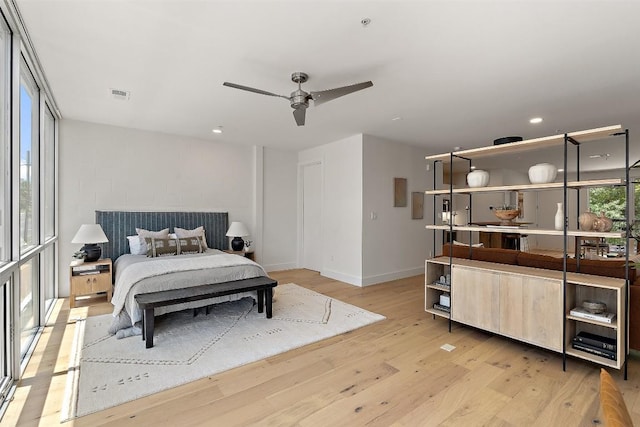 bedroom featuring light wood-style floors, recessed lighting, visible vents, and baseboards