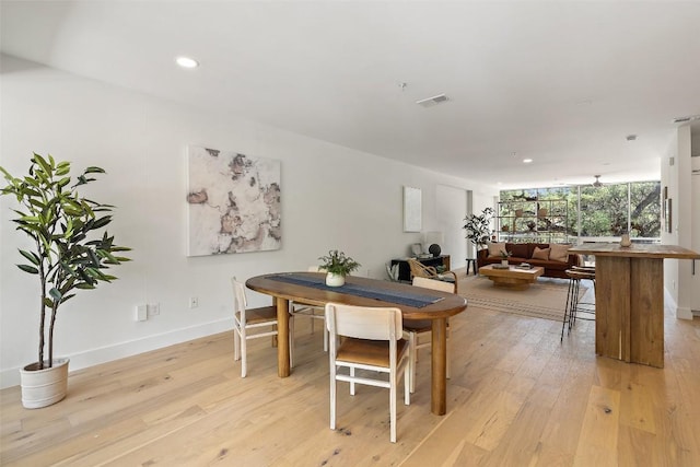 dining room with light wood-style flooring, visible vents, baseboards, and recessed lighting