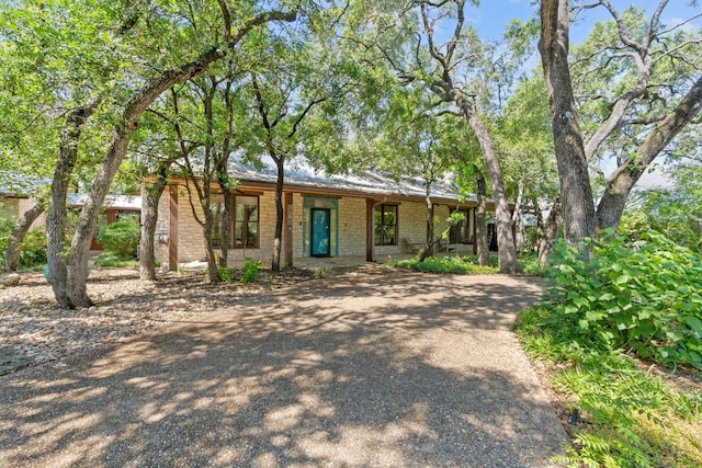 view of front of house with covered porch and brick siding