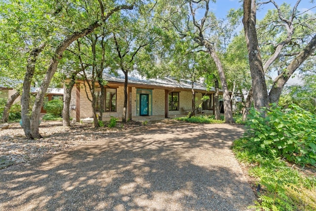 6615 La Concha Pass, Austin, TX 78749 - view of front of home featuring covered porch, brick siding, and driveway