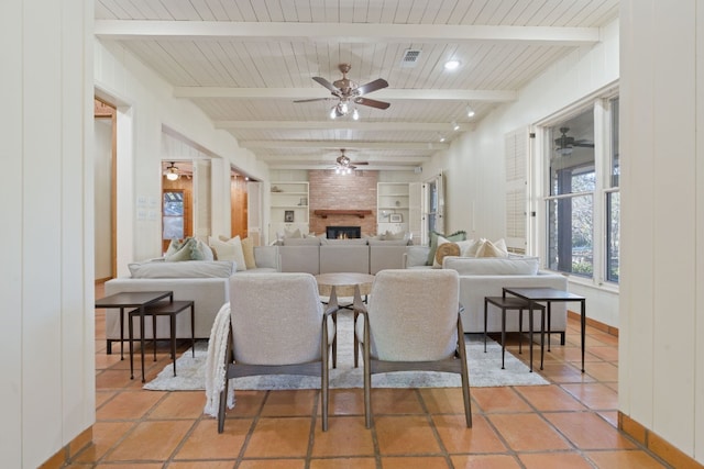 living room featuring a large fireplace, visible vents, wooden ceiling, built in shelves, and beam ceiling