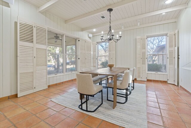 6615 La Concha Pass, Austin, TX 78749 - dining space with a chandelier, light tile patterned flooring, wooden walls, and baseboards