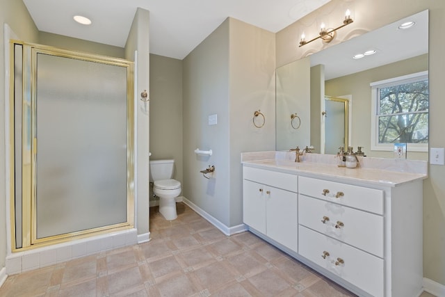 bathroom with recessed lighting, toilet, a shower stall, vanity, and baseboards