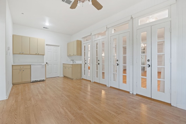 kitchen featuring french doors, light wood finished floors, light countertops, visible vents, and dishwasher