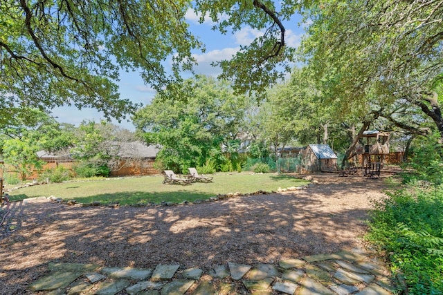 view of yard with an outdoor structure and a fenced backyard