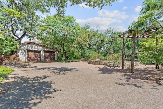 view of yard featuring a garage and an outdoor structure