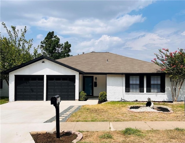 single story home featuring a garage, a shingled roof, concrete driveway, a front lawn, and brick siding