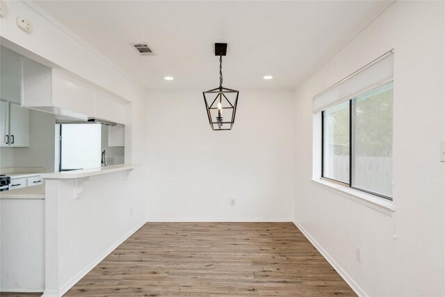 6705 Lancret Hill Dr, Austin, TX 78745 - unfurnished dining area with light wood-style flooring, recessed lighting, and baseboards