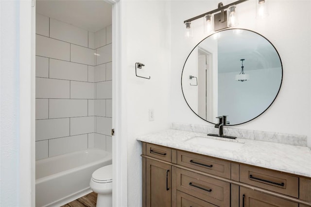 6705 Lancret Hill Dr, Austin, TX 78745 - full bath featuring vanity, toilet, washtub / shower combination, and wood finished floors