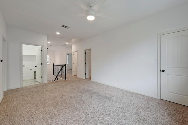 empty room with recessed lighting, light carpet, visible vents, and baseboards