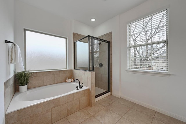 full bath featuring baseboards, a stall shower, a garden tub, and tile patterned floors