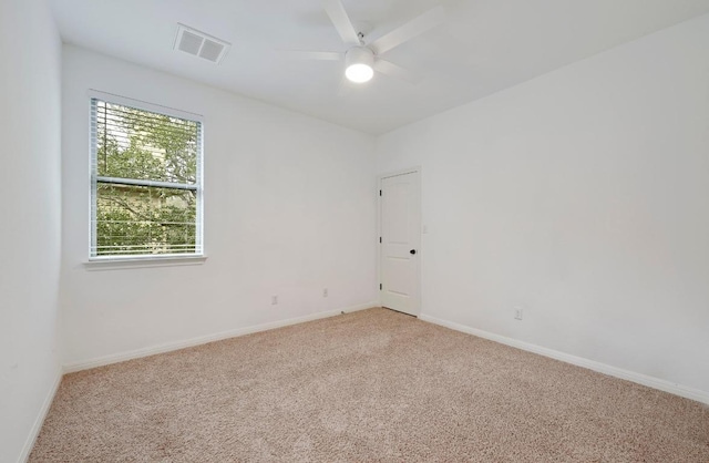 empty room with light carpet, baseboards, visible vents, and a ceiling fan