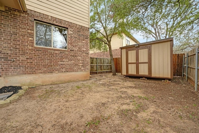 view of yard featuring a fenced backyard, an outdoor structure, and a shed