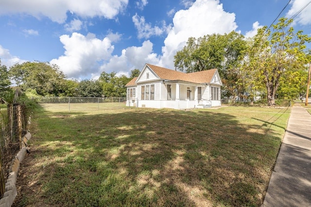 view of side of home featuring a yard and a fenced backyard