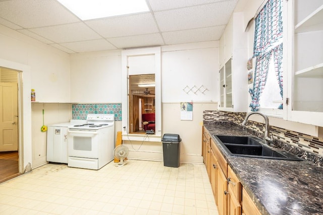 kitchen featuring a sink, electric range, a drop ceiling, and backsplash