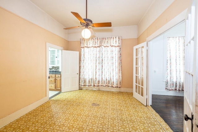 unfurnished dining area with ceiling fan and baseboards