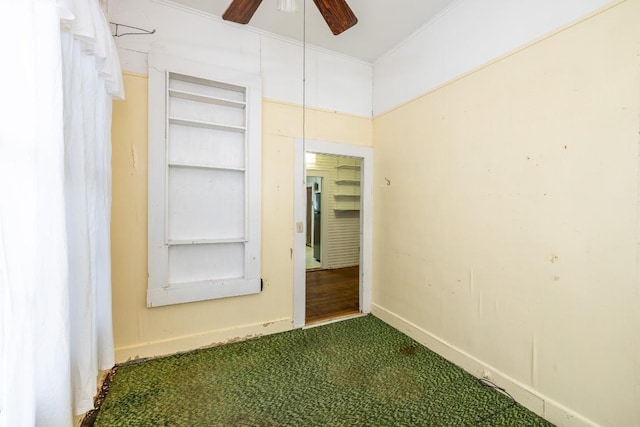 interior space featuring ceiling fan, carpet floors, and baseboards