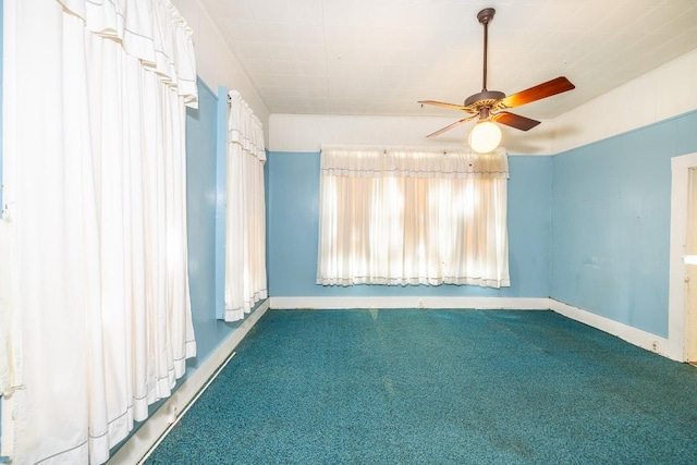 unfurnished room featuring carpet, baseboards, and ceiling fan